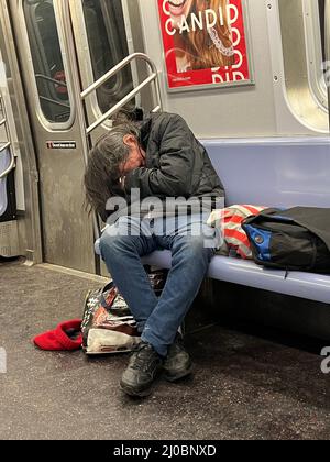 Homeless man with his belongings on the subway platform in the Grand ...