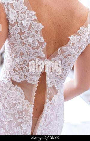 March 2022, bride photographed from behind wearing a loose dress Stock Photo