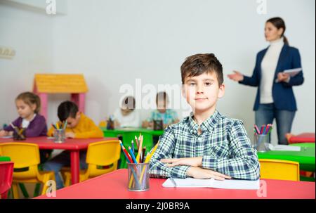 Smiling boy at pupils desk in school Stock Photo - Alamy