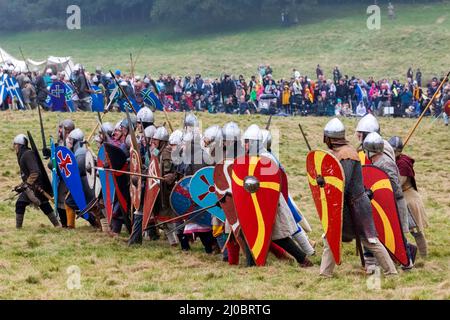 England, East Sussex, Battle, The Annual Battle of Hastings 1066 Re-enactment Festival, Participants Dressed in Medieval Norman Armour Advancing into Stock Photo