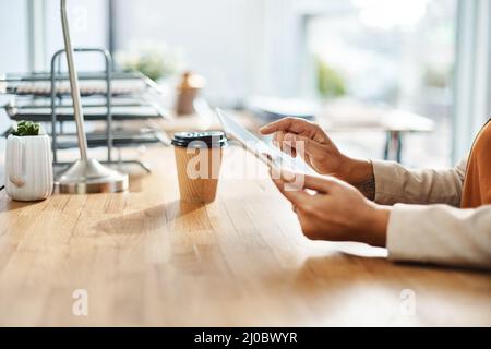 Theres an app for everything nowadays. Shot of an unrecognizable businesswoman using a digital tablet in her office. Stock Photo