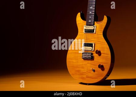 PRS guitar in Santana yellow on sunflower Stock Photo