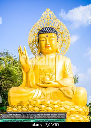 Gold Giant Buddha, Main Buddha Statue at Sanbanggulsa Temple, Sanbanggulsa is in Jeju-Do, Jeju Island in South Korea Stock Photo