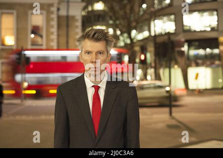 Businessman standing still at night Stock Photo