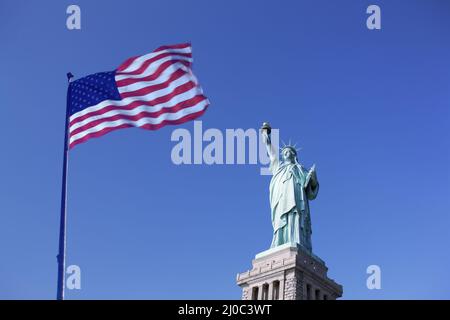 Statue of Liberty and the US Flag Stock Photo