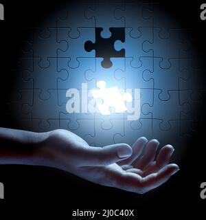 The pieces are falling into place. Conceptual shot of a persons hand building a puzzle. Stock Photo