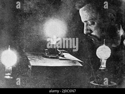 Reading by the light of the first lamp at Thomas Edison's Laboratory; Black and white photograph taken circa 1878s Stock Photo