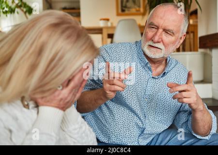 Domestic violence and jealousy in seniors Couple with crying wife and scolding senior Stock Photo