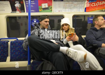 London, England, UK. People on a tube train looking at their mobile phones Stock Photo