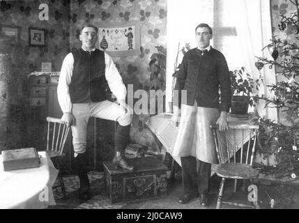 Authentic vintage photograph of two young men standing in lounge looking at camera, Sweden Stock Photo