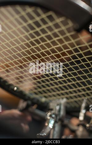 Racket stringing. Detail of tennis racket in the stringing machine Stock Photo