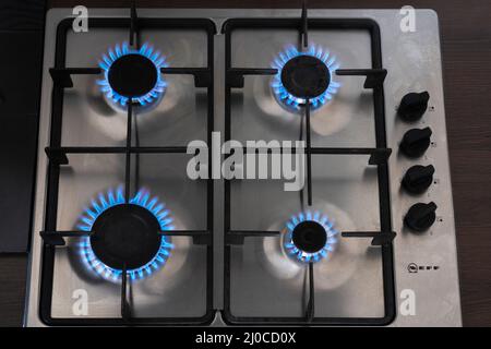 Blue flames on a natural gas cooker in England. Theme: energy price cap, rising energy bills, gas supply, gas supplies, Russian gas, high inflation Stock Photo