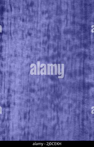Close up of smooth surface of shiny metallic wrapping film with chameleon effect, toned in very peri, color of year 2022. Neon abstract background wit Stock Photo