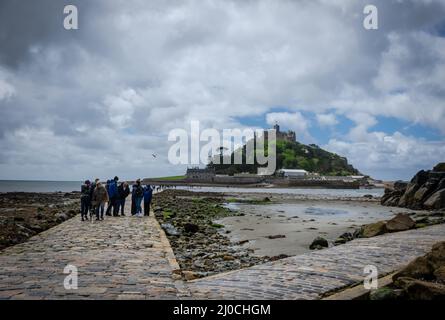 May 25th 2021 Marazion, Cornwall, England, UK - Pathway towards St. Michael's Mount, low tide, people around Stock Photo