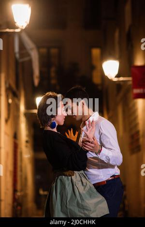 Perfect couple in love kissing, dancing on a city street at night. Stock Photo
