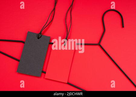 two empty, red and black labels lie on a bright background. Mockup for logo, tag Stock Photo