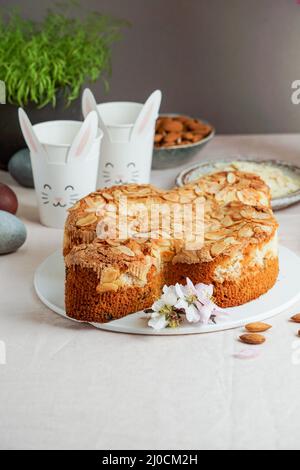 Colomba - traditional italian easter dove cake with glaze, macaranage, almonds Stock Photo