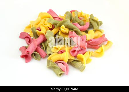 Pile of colorful campanelle pasta isolated on white background. Uncooked raw italian pasta Stock Photo