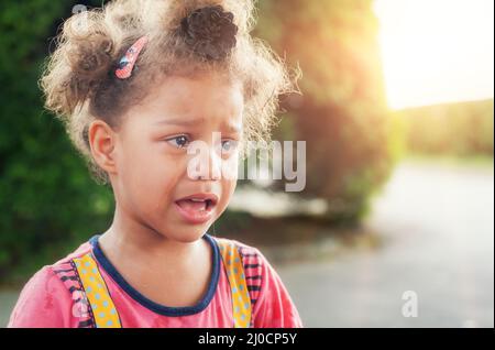 Portrait of little girl crying with tears rolling down her cheeks Stock Photo