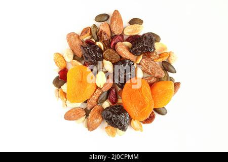 Mixture of dried fruits and nuts isolated on white background.Pile of dry apricots,prunes,candied cranberries,raisins and pumpkin seeds Stock Photo