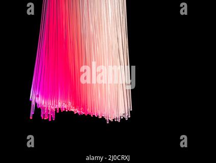 Colorful illuminated optical fibers closeup in black back Stock Photo