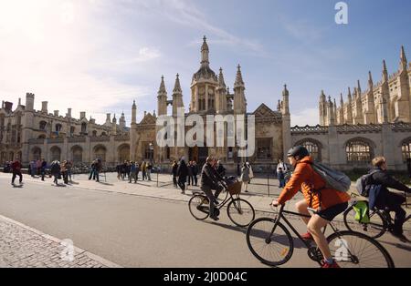 Cambridge cycling - people riding bicycles on a sunny spring day, Kings Parade, in front of Kings College , Cambridge City Centre, Cambridge UK Stock Photo