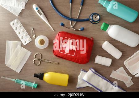 Assortment of portable medical equipment for rapid assistance in hospital on wooden table. Horizontal composition. Top view. Stock Photo