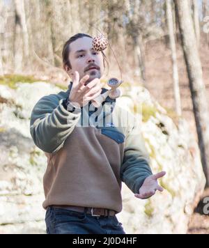 Young hip male playing kendama outdoors Stock Photo