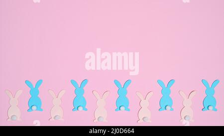 Pastel pink and blue rabbits on pastel pink background. Creative copy space Easter concept Stock Photo