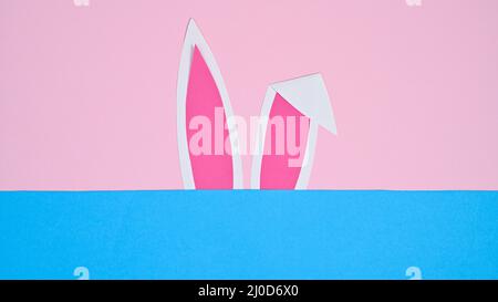 Bunny ears on pastel pink and blue background. FLat lay minimal creative concept Stock Photo