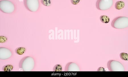 Easter frame with copy space on pastel pink background with white and quail eggs. Flat lay minimal concept Stock Photo