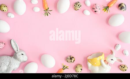Easter frame with copy space on pastel pink background with Easter decorations and eggs. Flat lay minimal concept Stock Photo