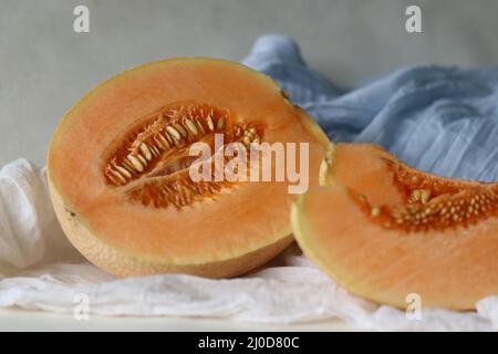 Muskmelon, also known as Cucumis melo, is a species of melon belongs to gourd family. It has ribbed, netted or smooth skin and a sweet, or bland flavo Stock Photo