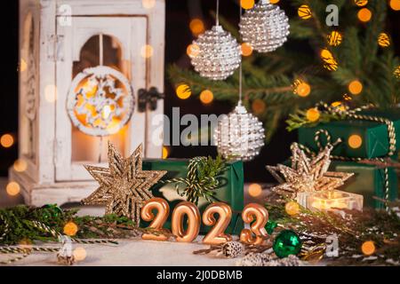 Abstract Advent 2023 Background. Christmas card with holiday mood. Festive burning candles. Christmas Decoration With gifts And Defocused Lights Stock Photo