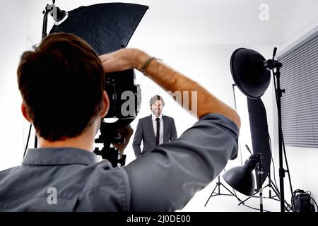 The photographers craft. Shot of a photographer working in his studio. Stock Photo