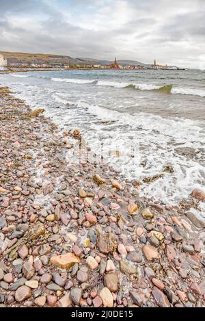 Largs seafront looking back to town centre. A seaside hoilday resort with a pebble beach & a good Victorian promenade.Largs is associated with Vikings Stock Photo