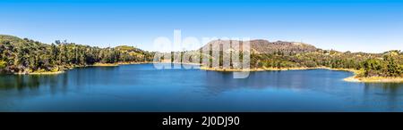 Panorama of Lake Hollywood Reservoir surrounded by steep hills covered in natural foliage is a favorite place for tourists and active people looking t Stock Photo