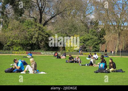 London, UK. 18th Mar, 2022. People sunbathe in St James' Park on a beautifully sunny day with temperatures of up to 17 degrees and clear blue skies throughout the day. Credit: Imageplotter/Alamy Live News Stock Photo