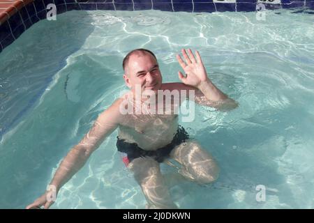 Man in Mask Posing near Woman in Swimming Pool · Free Stock Photo