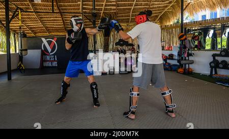 Cabarete, Puerto Plata, Dominican republic, 12.03.2022. Kickboxing at school under a canopy. Spaving, boxing. Gym. Wide angle, High quality photo -5 Stock Photo