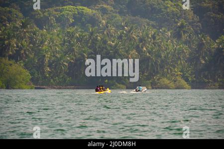 Malvan, INDIA - December 23, 2021 : Unidentified tourist enjoying a Banana ride at Tarkarli beach. The beach is famous for various water sports activi Stock Photo