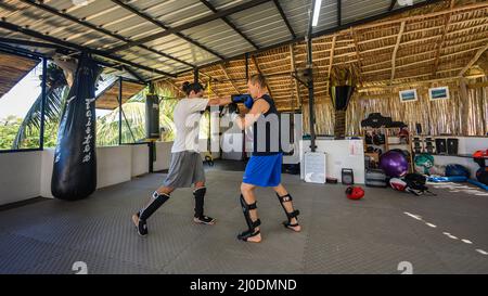 Cabarete, Puerto Plata, Dominican republic, 12.03.2022. Kickboxing at school under a canopy. Spaving, boxing. Gym. Wide angle, High quality photo -5 Stock Photo