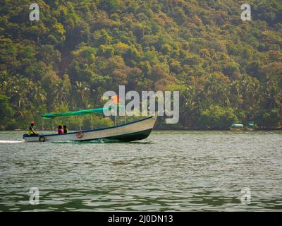 Malvan, INDIA - December 23, 2021 : Unidentified tourists enjoying boat ride in  Devbagh beach, Sindhudurga, a place listed in 30 favorite tourist des Stock Photo