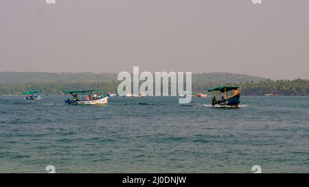 Malvan, INDIA - December 23, 2021 : Unidentified tourists enjoying boat ride in  Devbagh beach, Sindhudurga, a place listed in 30 favorite tourist des Stock Photo