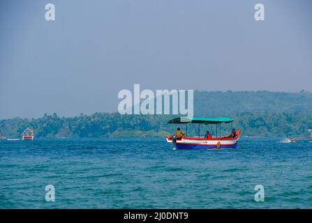 Malvan, INDIA - December 23, 2021 : Unidentified tourists enjoying boat ride in  Devbagh beach, Sindhudurga, a place listed in 30 favorite tourist des Stock Photo