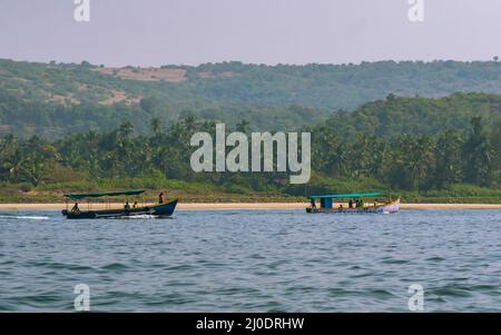 Malvan, INDIA - December 23, 2021 : Unidentified tourists enjoying boat ride in  Devbagh beach, Sindhudurga, a place listed in 30 favorite tourist des Stock Photo