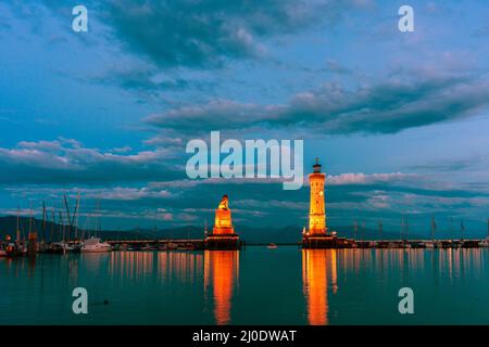 View of the harbor entrance and lighthouse in Lindau on Lake Constance. Stock Photo