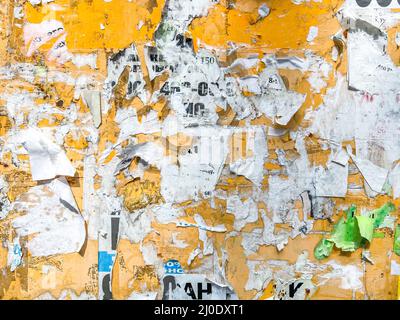 Yellow Old Billboard With Torn Posters And Ads Background Stock Photo
