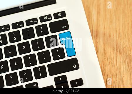 My post is all ready to go. High angle shot of a highlighted key of a bloggers laptop on a desk during the day. Stock Photo