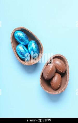 Sweet chocolate eggs on blue background Stock Photo